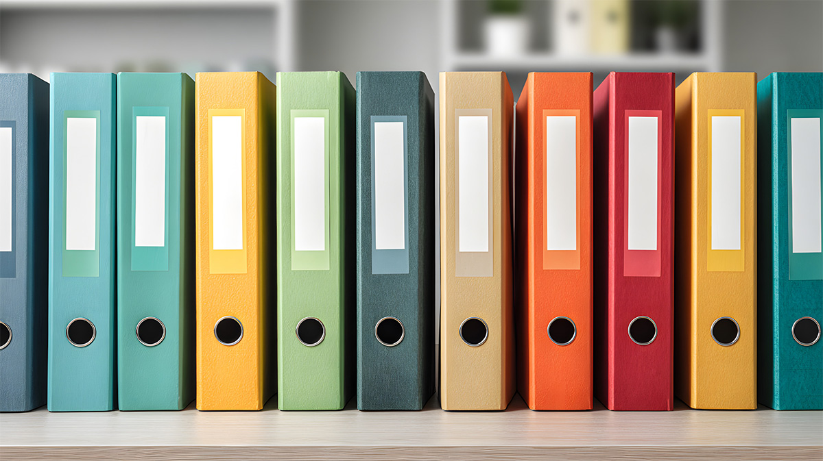 Database Activity Monitoring Multi-colored binders arranged neatly in a row