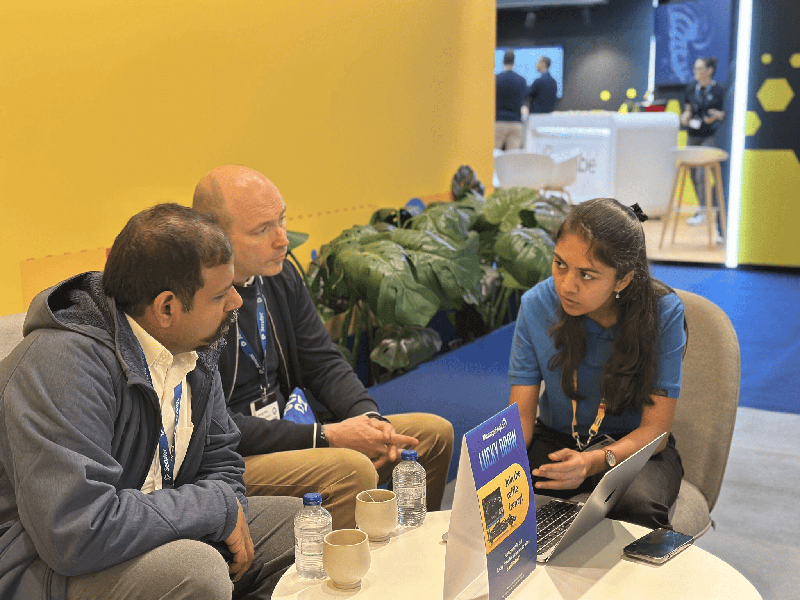 Attendees in conversation at the PAM360 booth